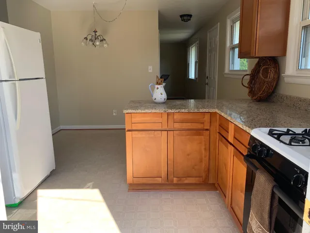a kitchen with a refrigerator and a stove