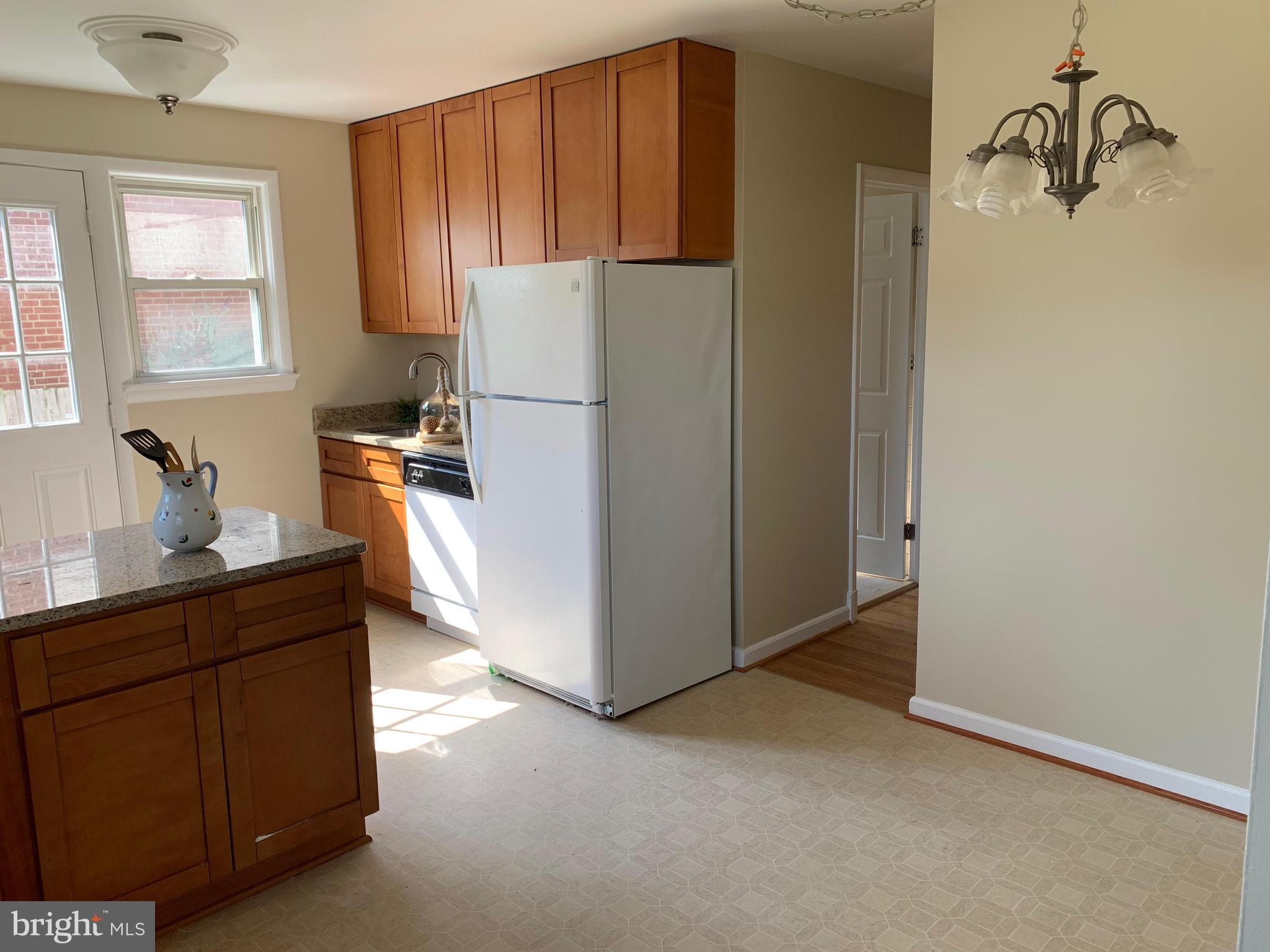 6408 Winnepeg Road Bethesda, MD 20817 - Photo 3 of 14 a kitchen with cabinets a refrigerator and a sink