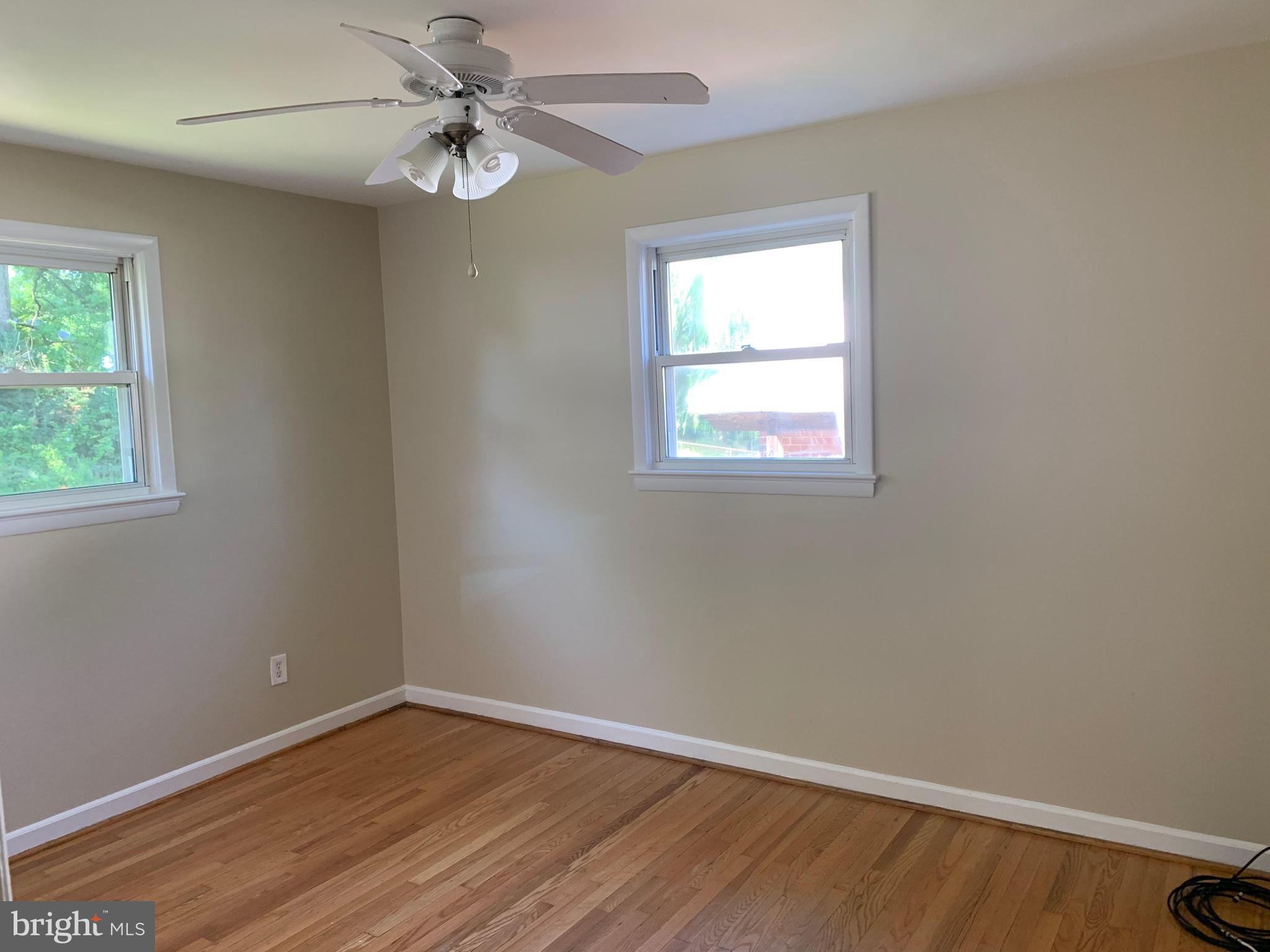 6408 Winnepeg Road Bethesda, MD 20817 - Photo 7 of 14 an empty room with a window and a fan