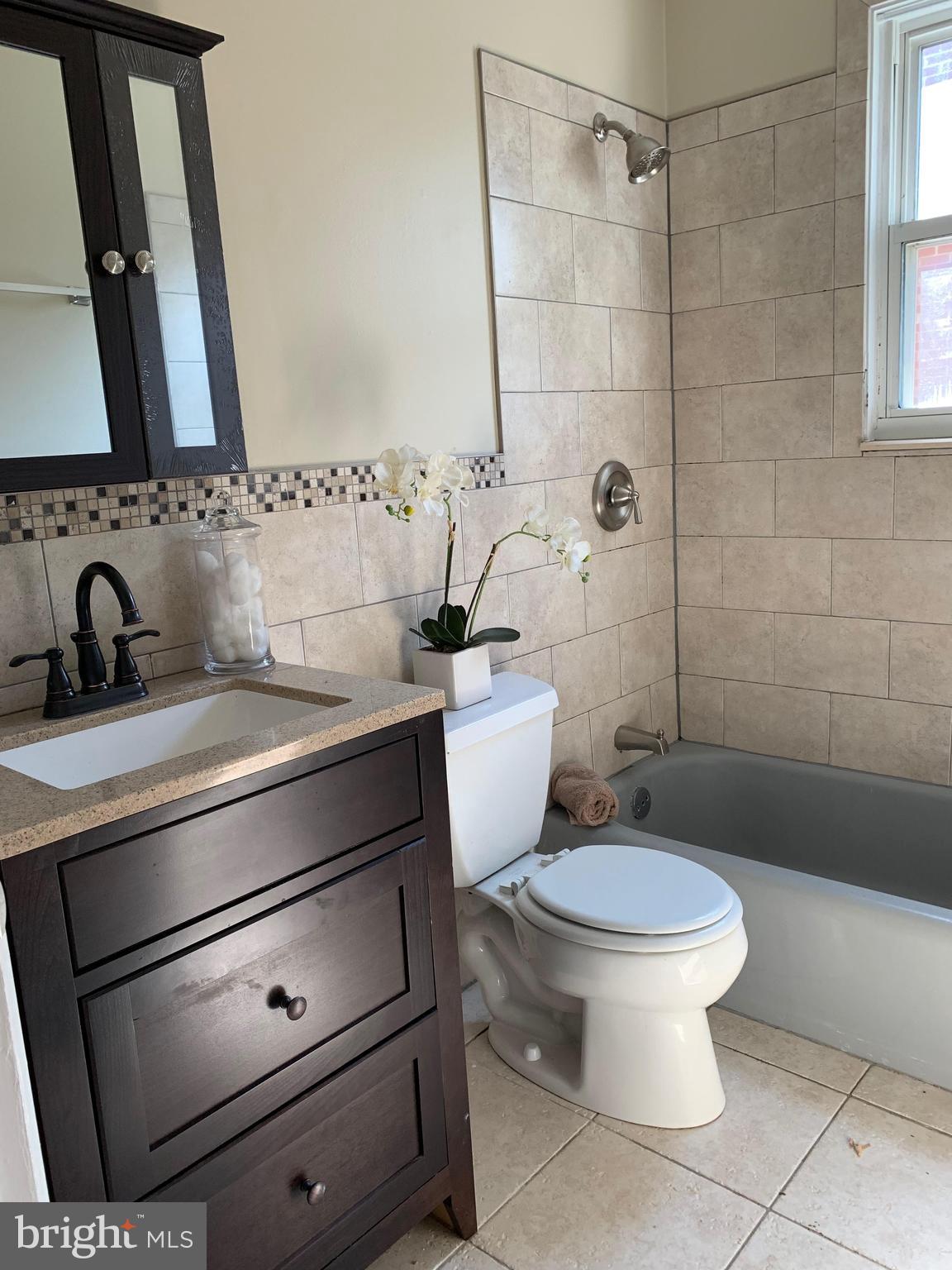 6408 Winnepeg Road Bethesda, MD 20817 - Photo 8 of 14 a bathroom with a sink toilet and shower