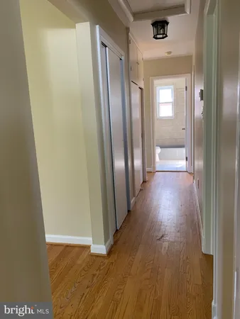 a view of a hallway with wooden floor