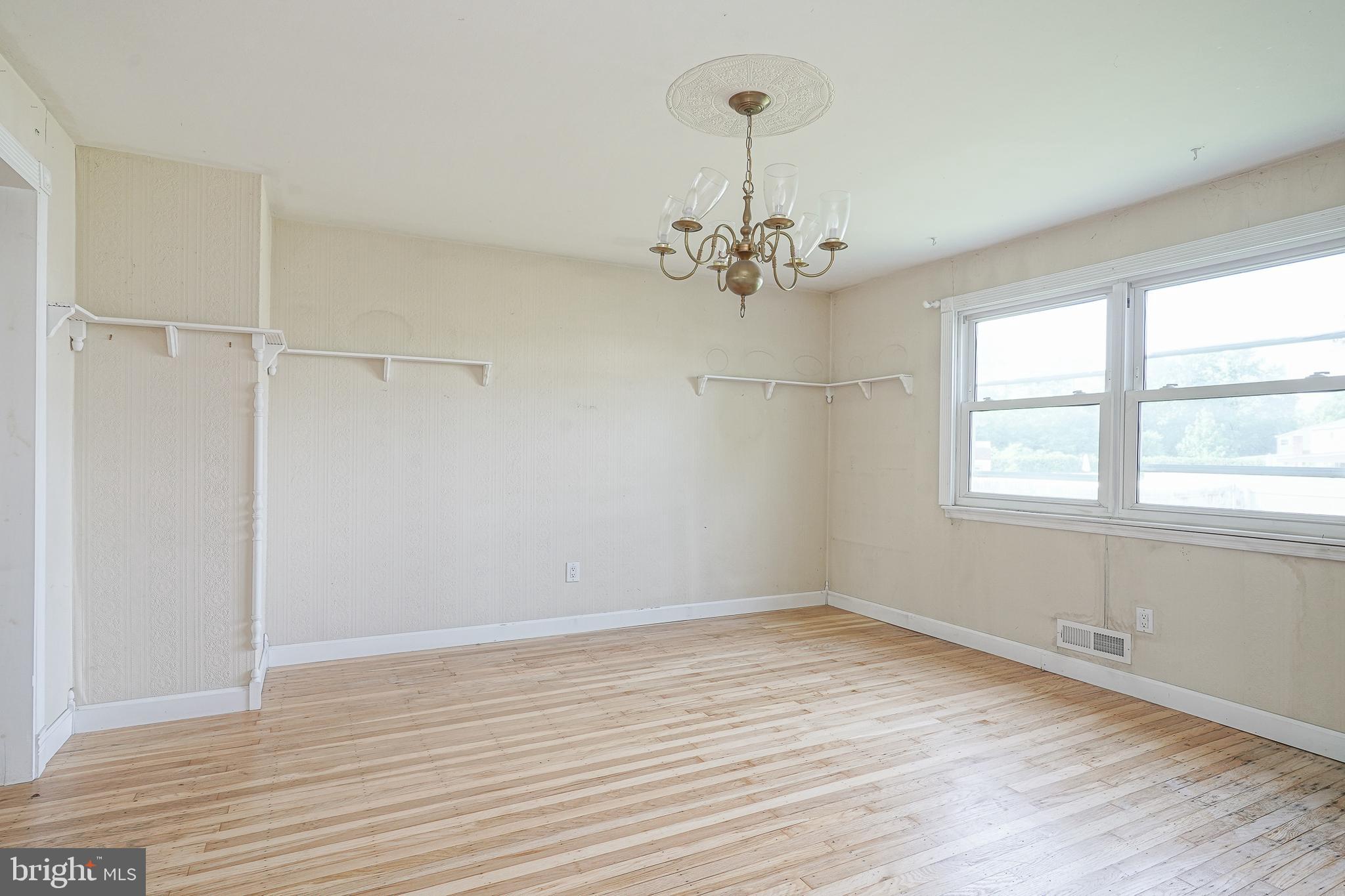 152 Kelly Driver Road Laurel Springs, NJ 08021 - Photo 7 of 30 a view of empty room with wooden floor fan and window
