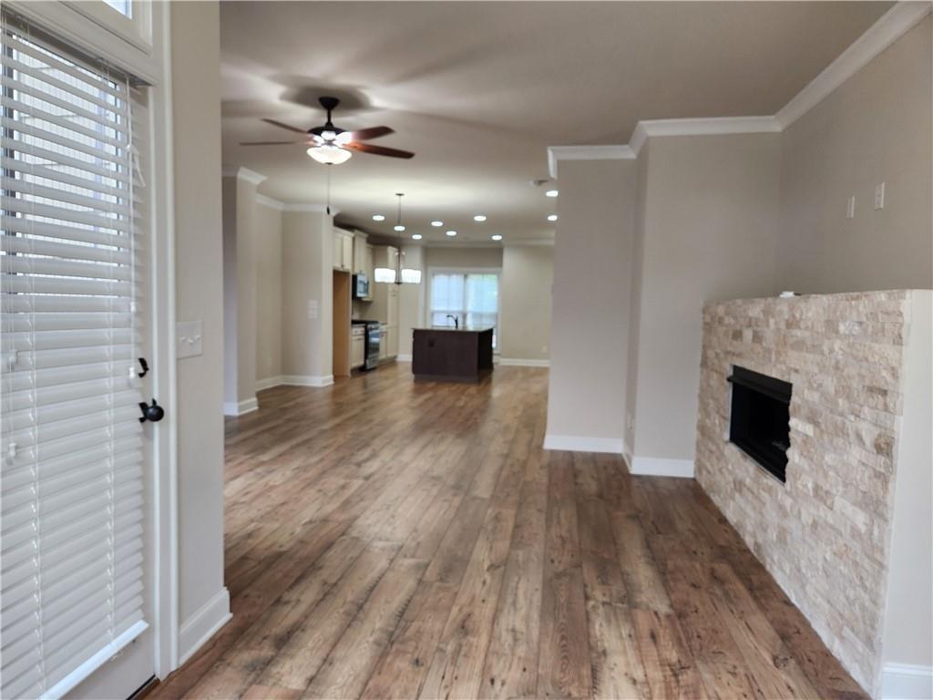 1323 Faircrest Way Suwanee, GA 30024 - Photo 10 of 16 a view of a livingroom with a furniture wooden floor and a ceiling fan