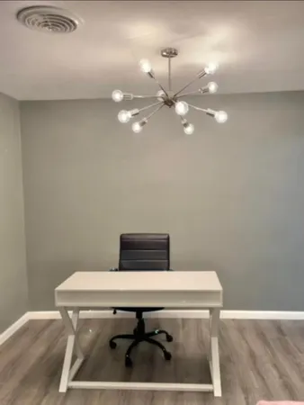 a room with a table chairs and wooden floor