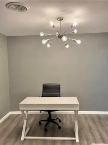a room with a table chairs and wooden floor