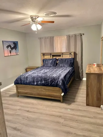 a bedroom with a bed and a chandelier