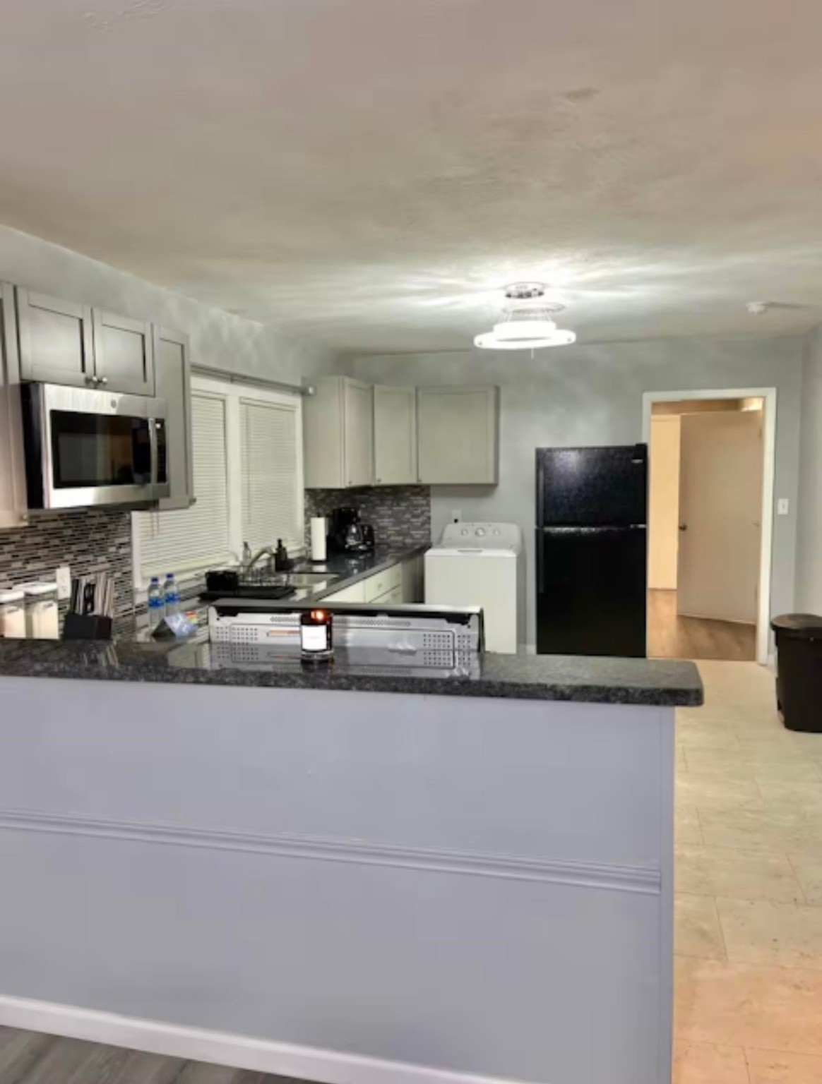 1908 North 16th Street Orange, TX 77630 - Photo 4 of 18 a view of a kitchen with a sink and a stove top oven