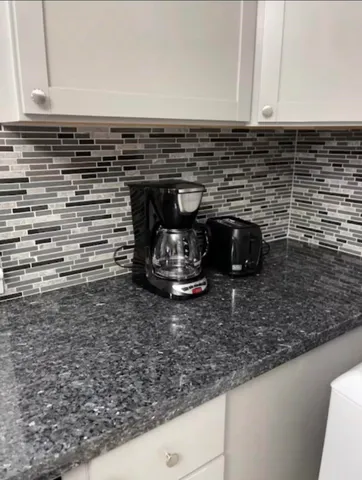 a close view of a stove a microwave and cabinets
