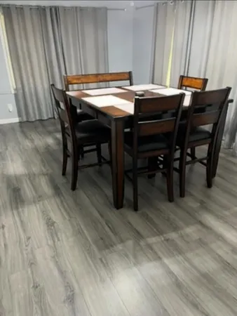 a view of a dining room with furniture and wooden floor