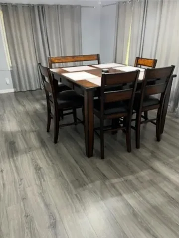 a view of a dining room with furniture and wooden floor