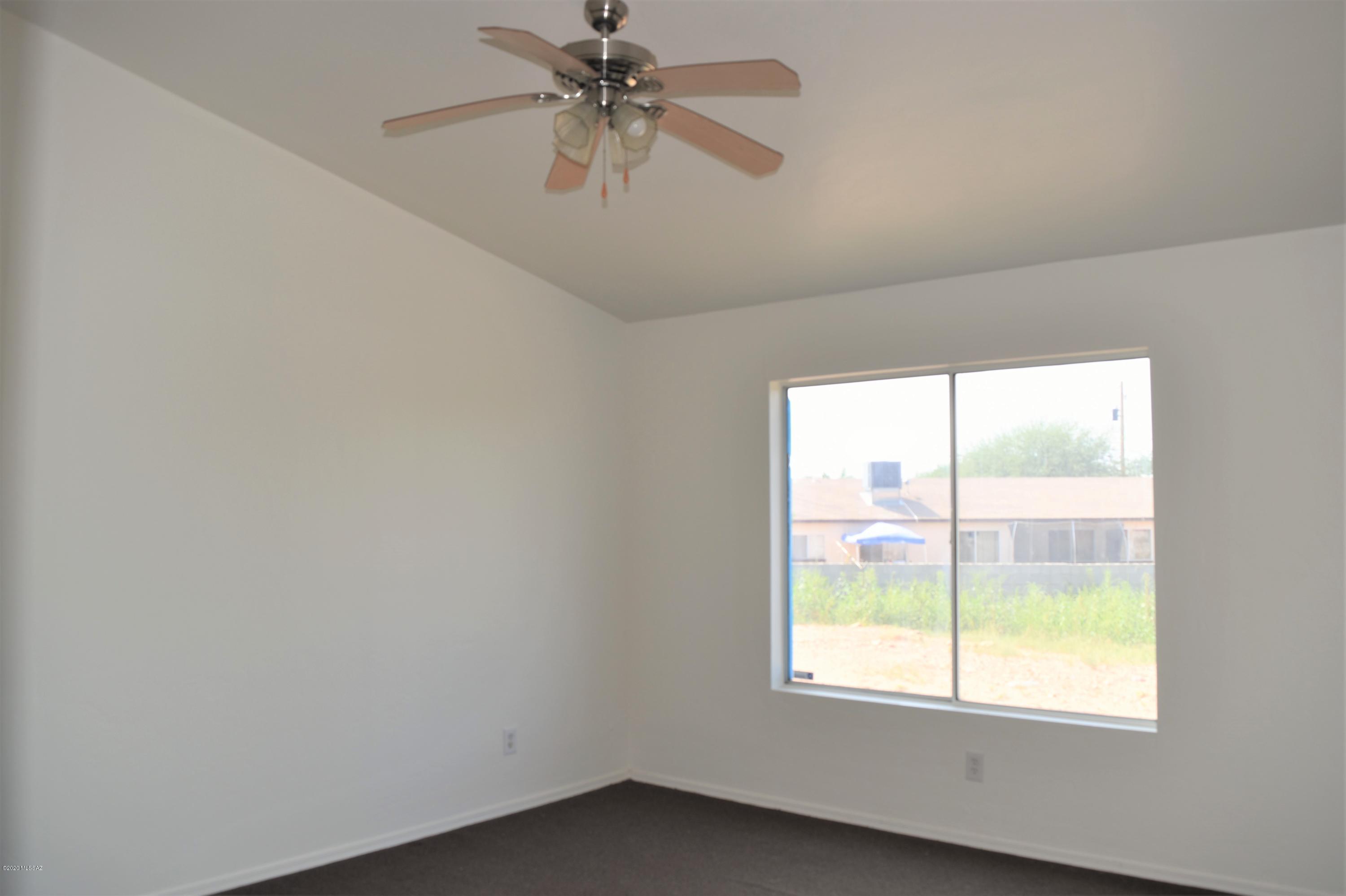 146 Nee Court Rio Rico, AZ 85648 - Photo 9 of 13 wooden floor in an empty room with a window