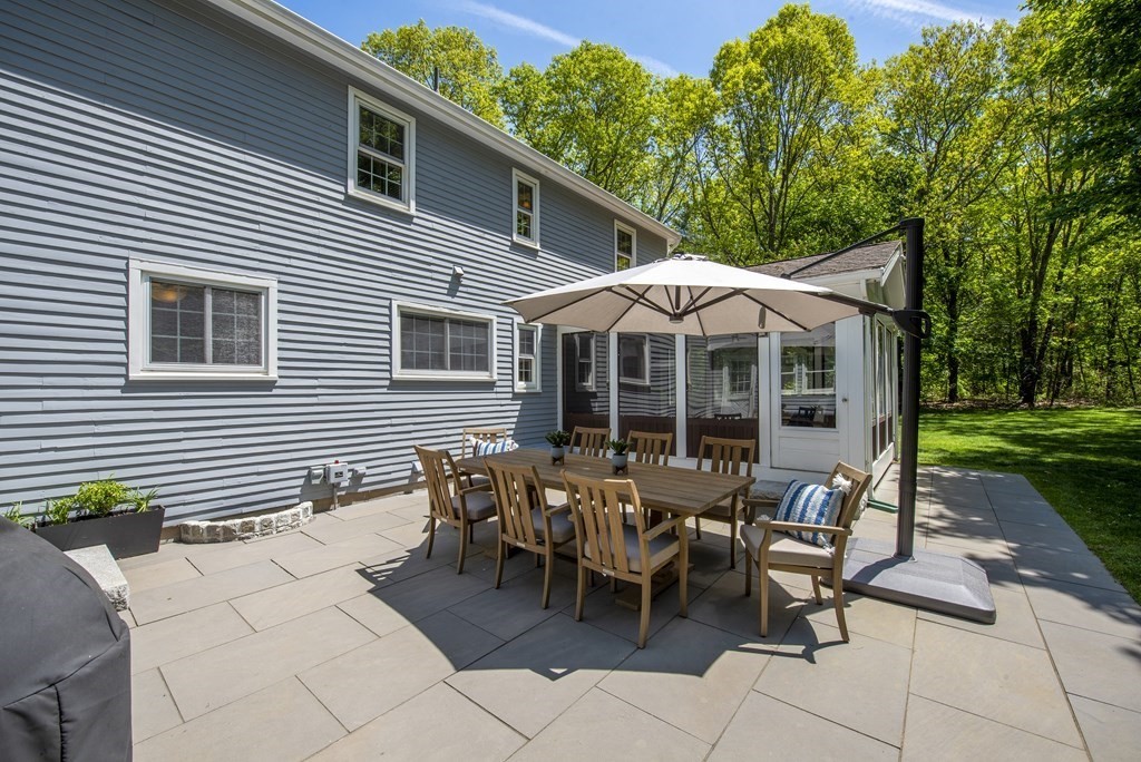 2 Pye Brook Lane Boxford, MA 01921 - Photo 23 of 30 a view of a patio with table and chairs under an umbrella