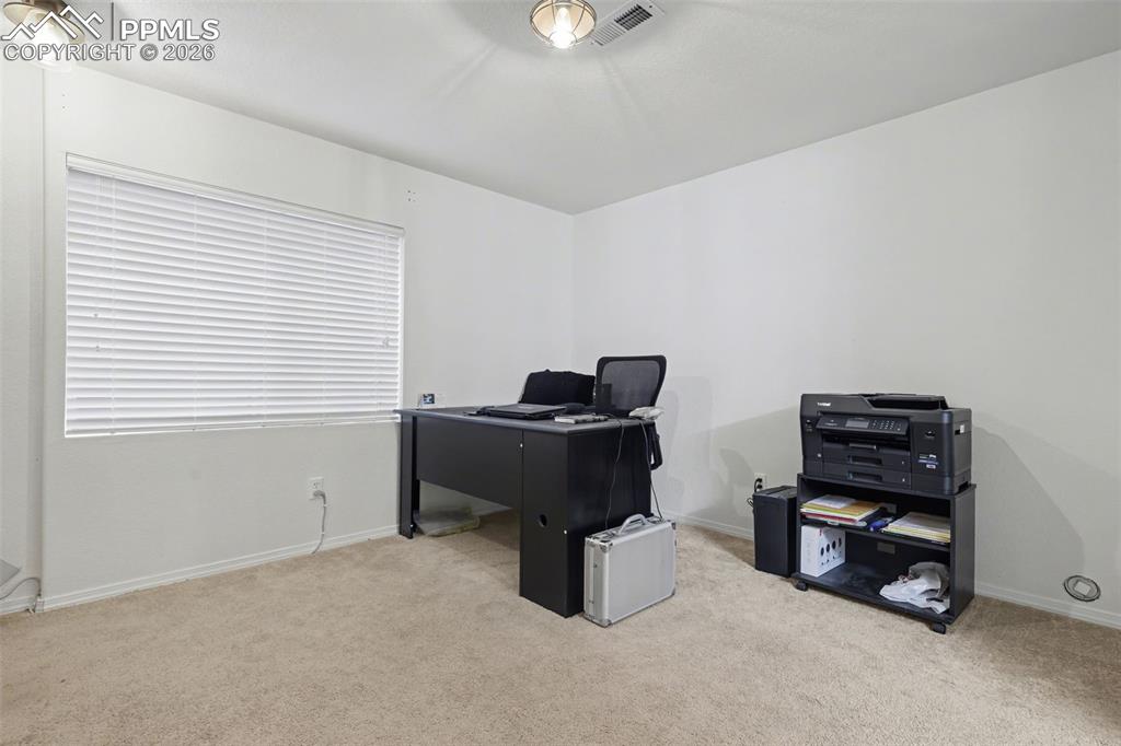 2579 Malpaso Point Colorado Springs, CO 80922 - Photo 11 of 15 a living room with furniture and a window