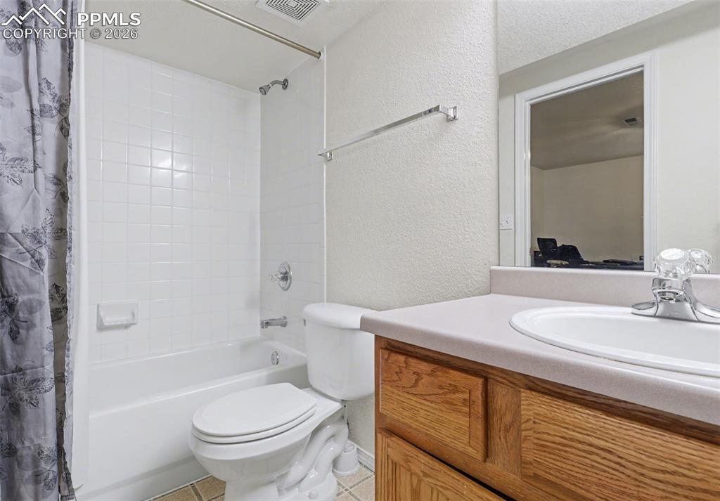 2579 Malpaso Point Colorado Springs, CO 80922 - Photo 12 of 15 a bathroom with a sink a toilet and shower