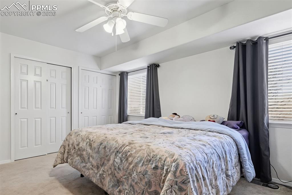 2579 Malpaso Point Colorado Springs, CO 80922 - Photo 6 of 15 a bedroom with a large bed and a chandelier