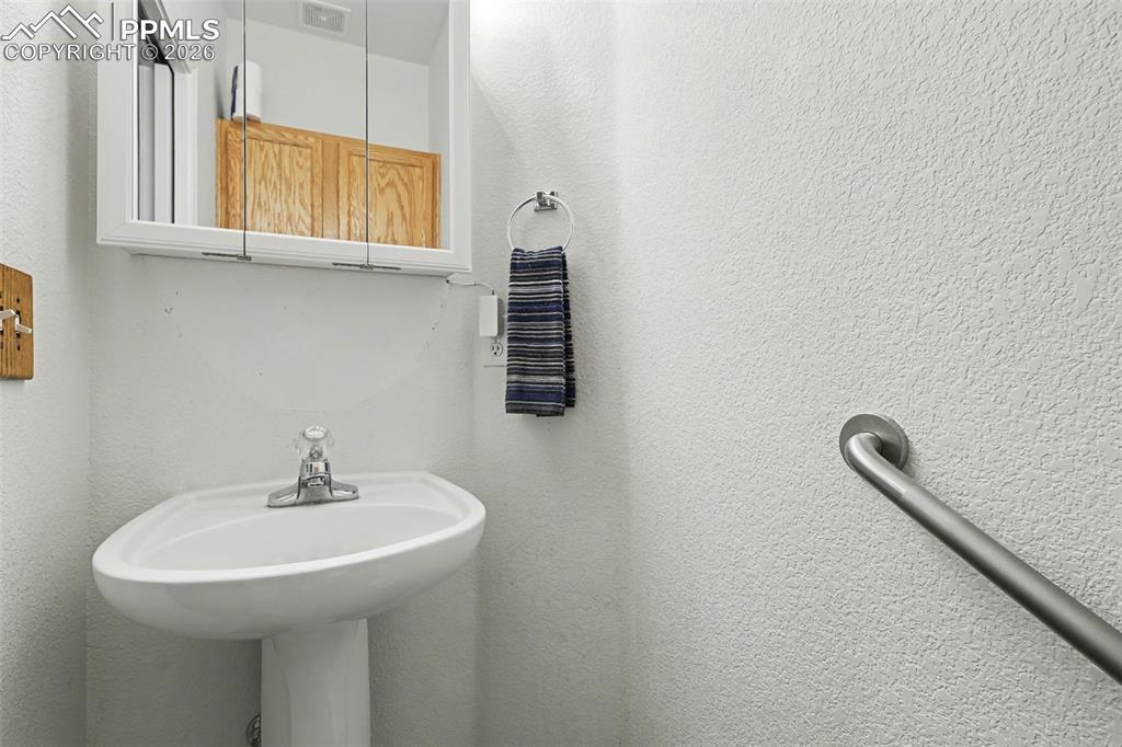 2579 Malpaso Point Colorado Springs, CO 80922 - Photo 10 of 15 a bathroom with a sink and a mirror