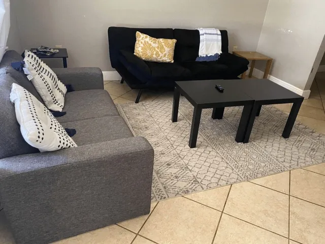 a living room with furniture and a mirror