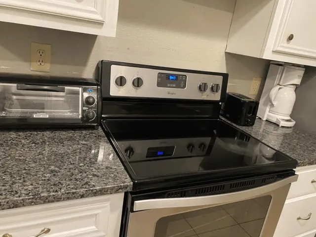a stove top oven sitting inside of a kitchen
