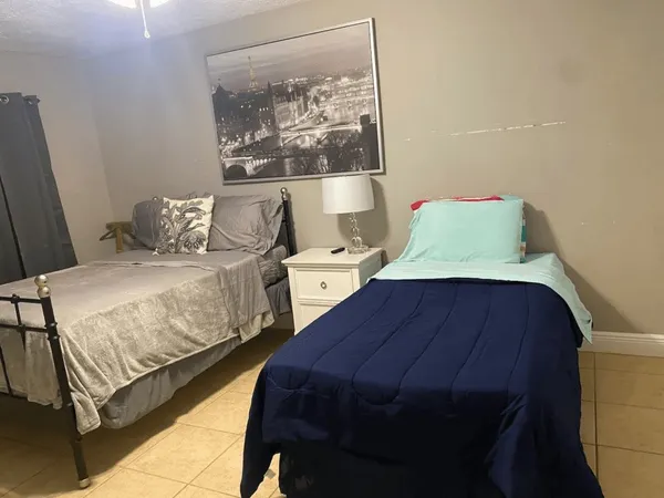 a bedroom with a bed and window