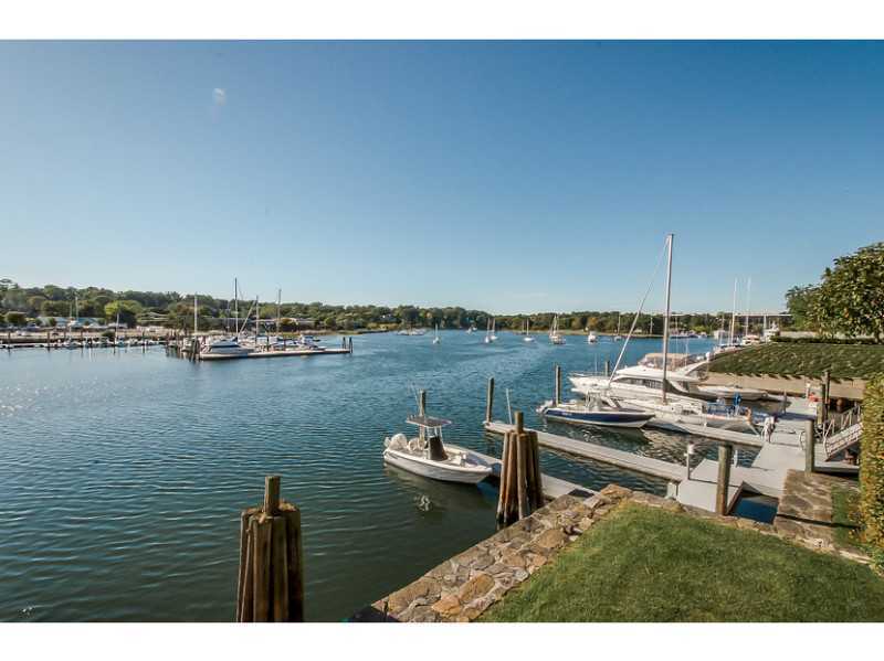 630 Steamboat Road, Unit 1A Greenwich, CT 06830 - Photo 3 of 24 a view of a lake with couches in wooden floor
