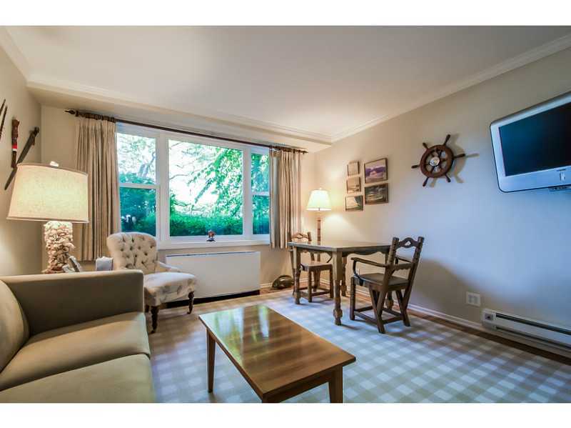 630 Steamboat Road, Unit 1A Greenwich, CT 06830 - Photo 7 of 24 a living room with furniture and a floor to ceiling window