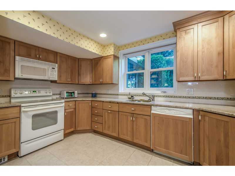 630 Steamboat Road, Unit 1A Greenwich, CT 06830 - Photo 9 of 24 a kitchen with stainless steel appliances granite countertop a stove a sink and a microwave