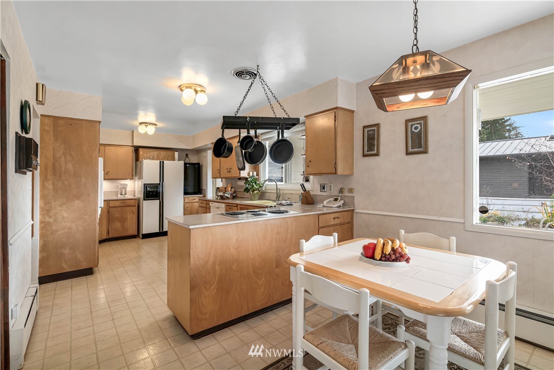 426 Bayside Road Bellingham, WA 98225 - Photo 15 of 40 a kitchen with stainless steel appliances granite countertop a sink a refrigerator and a stove