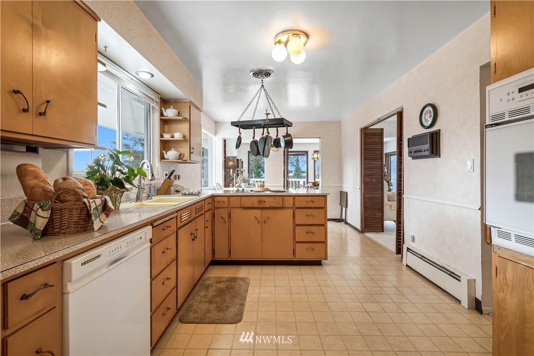 426 Bayside Road Bellingham, WA 98225 - Photo 17 of 40 a kitchen with stainless steel appliances a sink stove and refrigerator