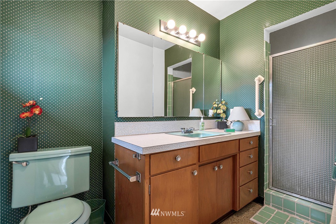 426 Bayside Road Bellingham, WA 98225 - Photo 26 of 40 a bathroom with a toilet sink vanity granite and mirror