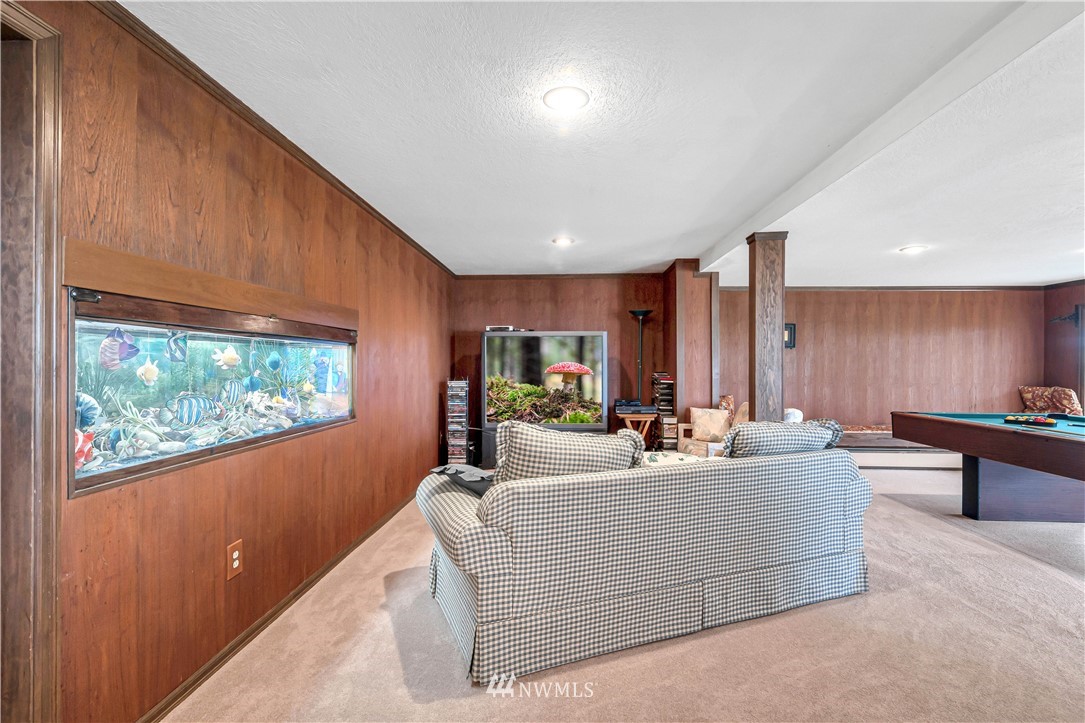 426 Bayside Road Bellingham, WA 98225 - Photo 28 of 40 a living room with large window furniture and a wooden floor