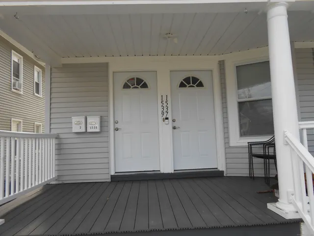 a view of a hallway with wooden floor and closet area