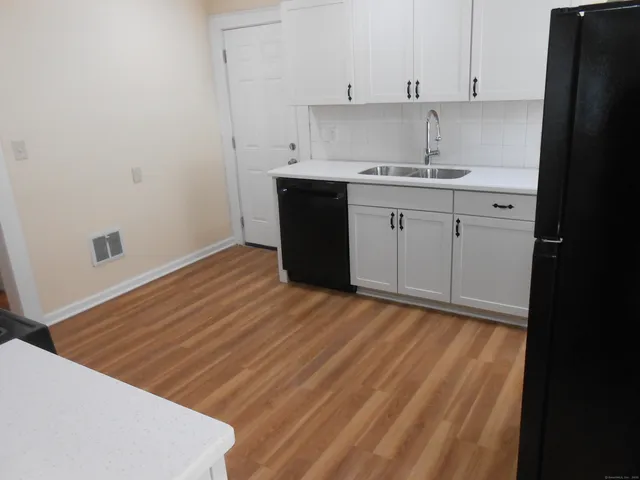 a kitchen with a sink and cabinets