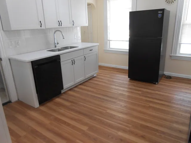 a kitchen with a sink and a window