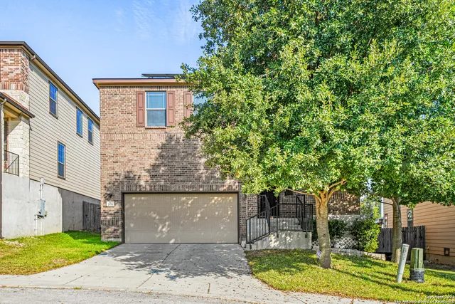 a front view of a house with a garden and plants