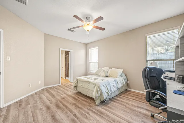 a bathroom with a granite countertop sink a toilet and a mirror