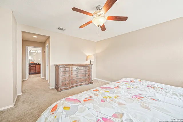 a bathroom with a toilet a sink and a large mirror