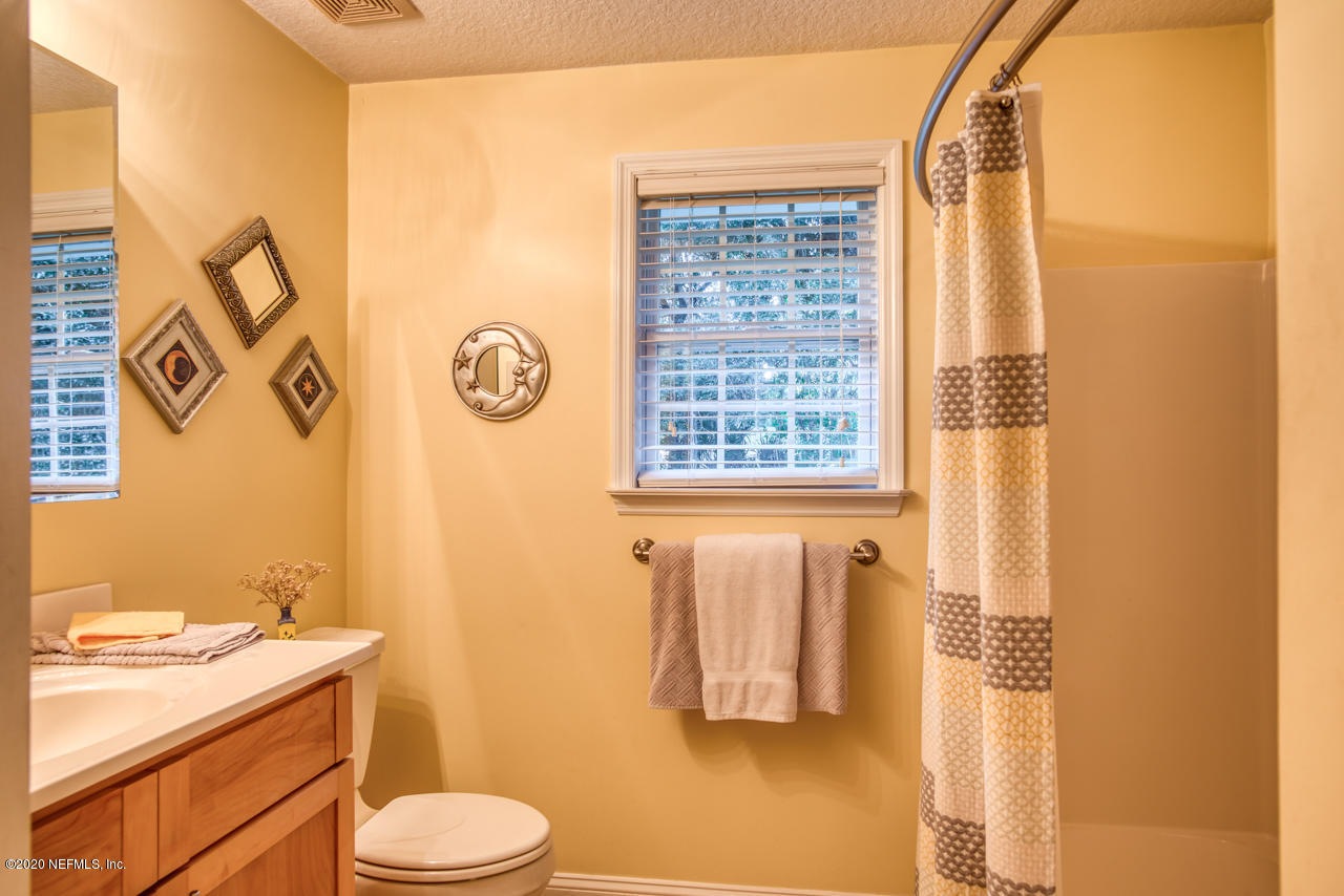 7020 Catlett Road St. Augustine, FL 32095 - Photo 27 of 50 a bathroom with a granite countertop toilet sink and tub