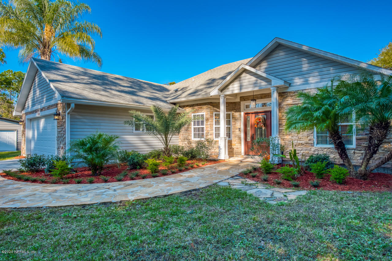7020 Catlett Road St. Augustine, FL 32095 - Photo 3 of 50 a front view of a house with a yard and potted plants