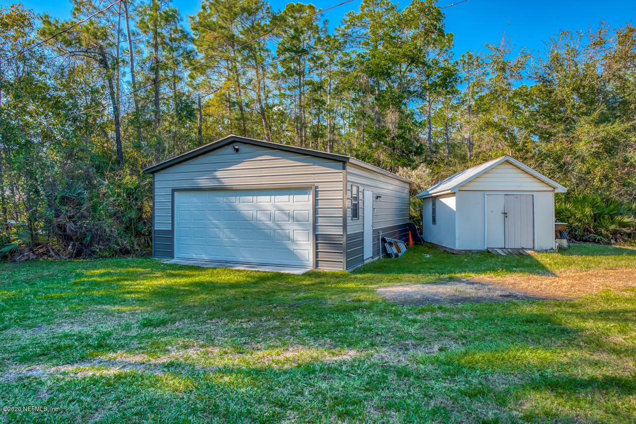 7020 Catlett Road St. Augustine, FL 32095 - Photo 41 of 50 a front view of a house with a yard and trees
