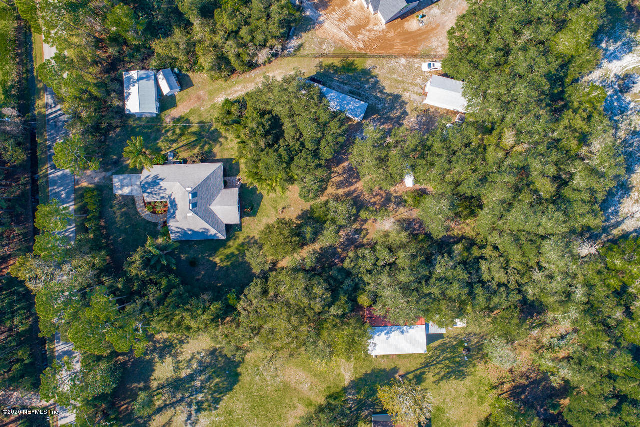 7020 Catlett Road St. Augustine, FL 32095 - Photo 45 of 50 an aerial view of a house with a yard and large trees