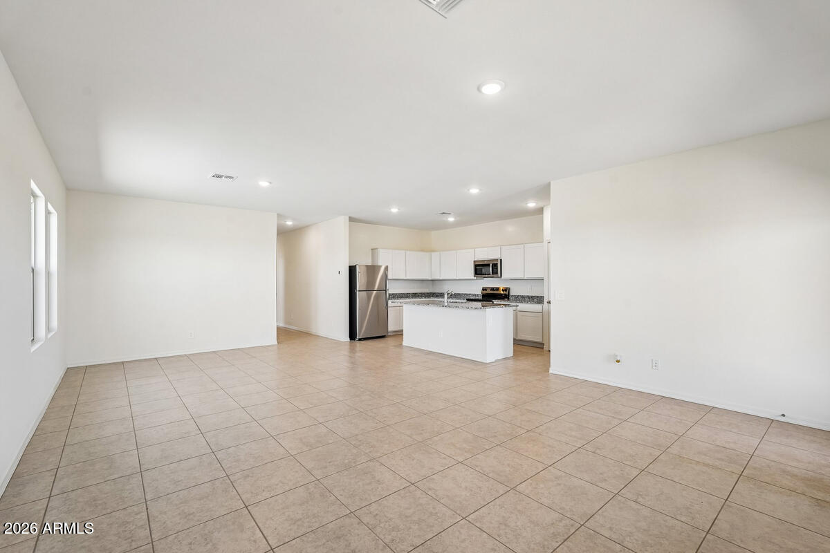 31690 Rodeo Road San Tan Valley, AZ 85140 - Photo 2 of 35 a view of kitchen with kitchen island granite countertop white cabinets and stainless steel appliances