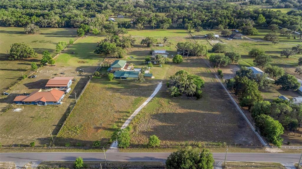 20138 Bowman Road Spring Hill, FL 34610 - Photo 1 of 40 an aerial view of a house with a yard and lake view