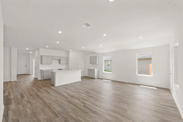 a view of kitchen with kitchen island sink refrigerator and window