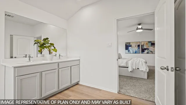 a en suite bathroom with a granite countertop sink