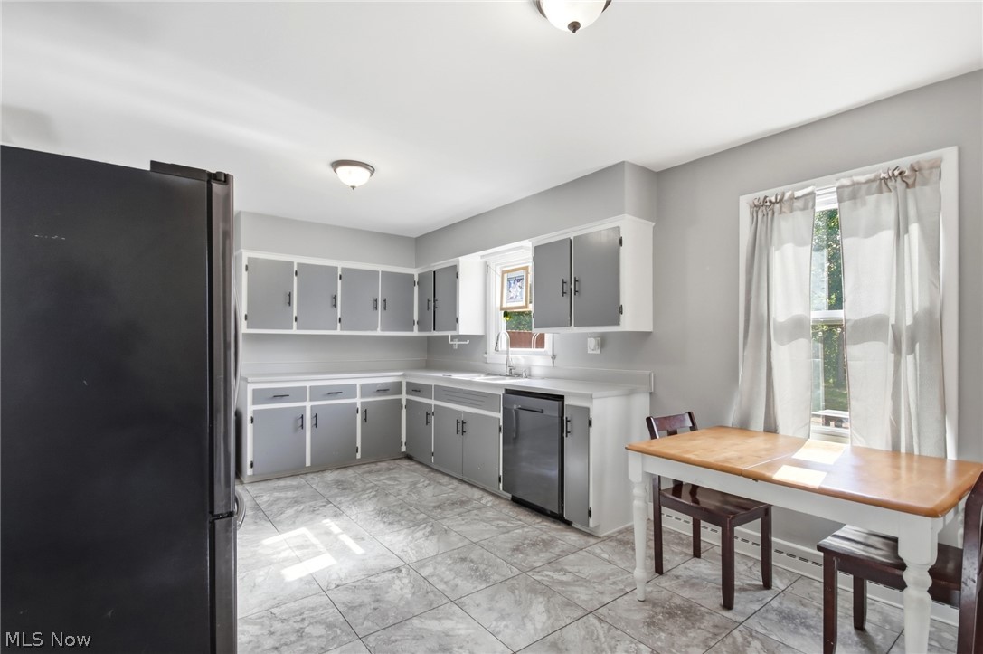 12684 Taylor Wells Road Chardon, OH 44024 - Photo 25 of 40 Kitchen featuring L-shaped cabinetry, a stainless steel dishwasher, and tiled flooring