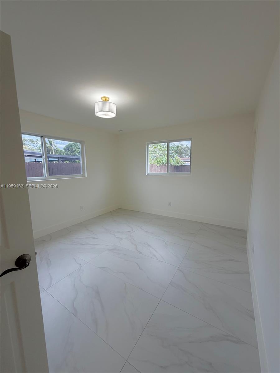 19221 Southwest 92nd Road Cutler Bay, FL 33157 - Photo 24 of 30 an empty room with a window