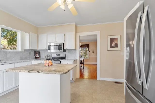 a kitchen with stainless steel appliances granite countertop a refrigerator sink and stove