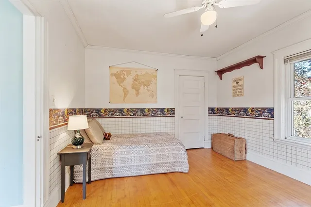 a bedroom with a bed and a table with potted plants