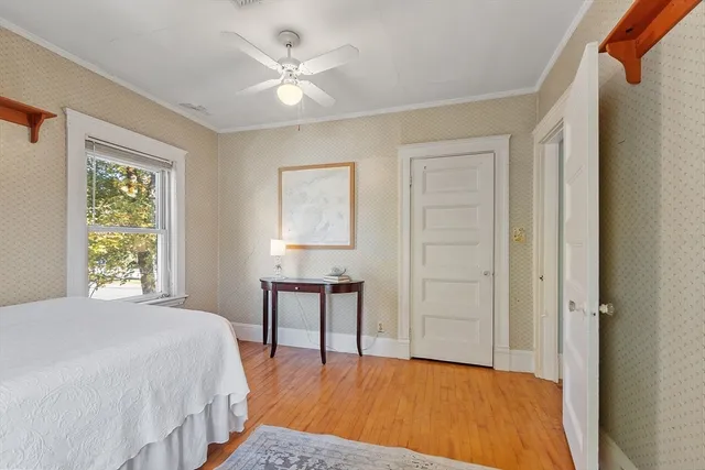 a bedroom with a bed and a table lamp