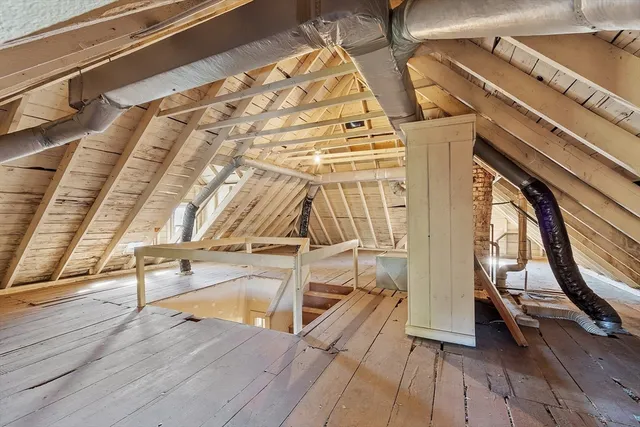 a view of a room with wooden floor